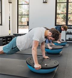 a man doing planks in the gym