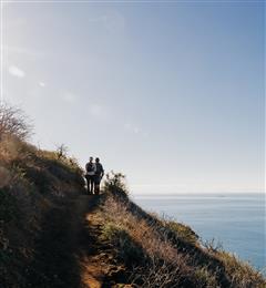 people hiking by ocean