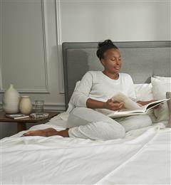 A woman resting on her bed