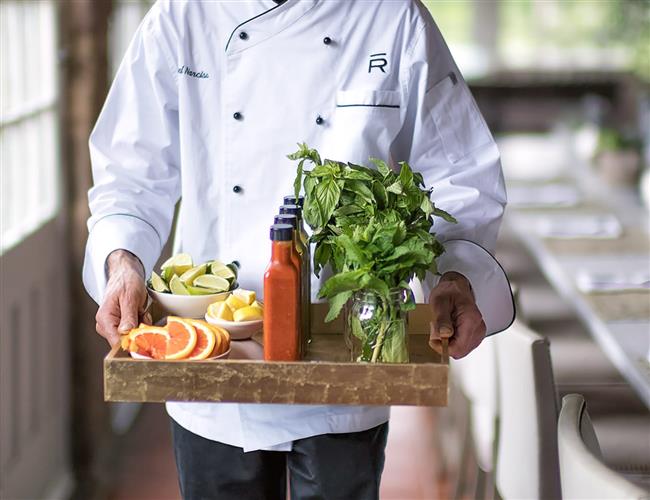 Man carrying tray of garnishes