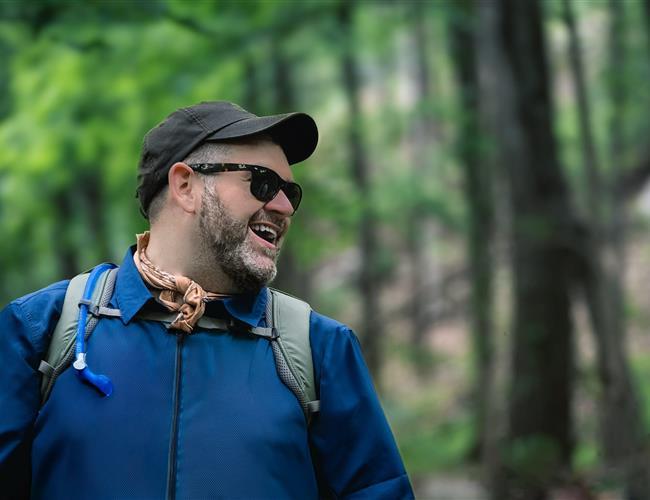 Man hiking with a smile