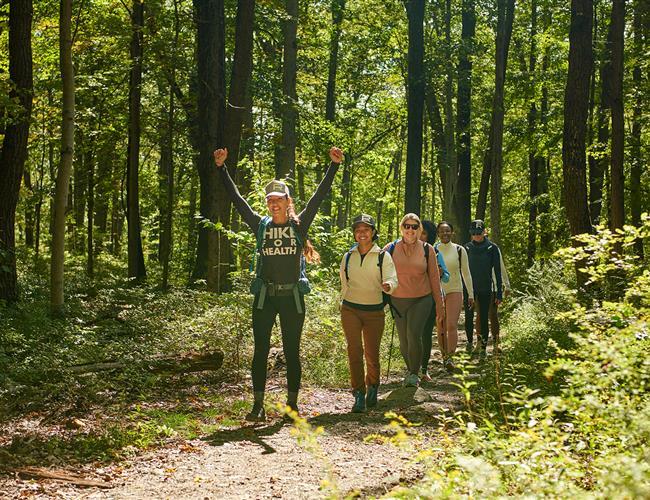 A group of hikers with a victory pose