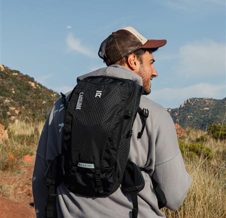 a man hiking and smiling 