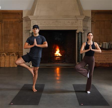 People doing yoga by the fireplace