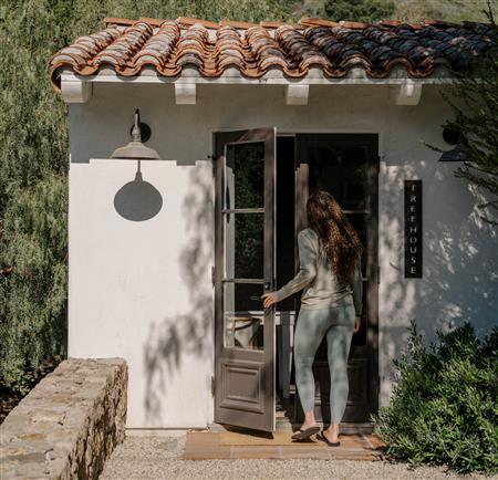 A woman entering the fitness room