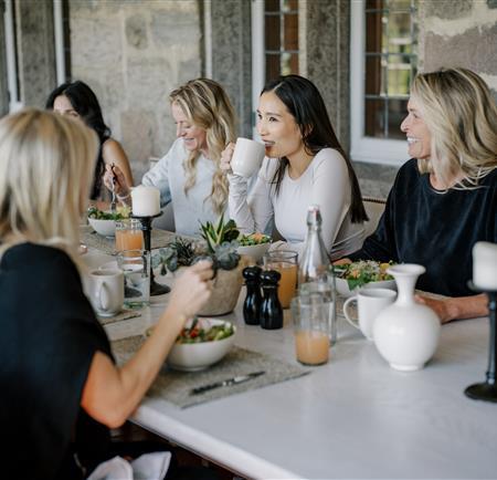 women eating around a table