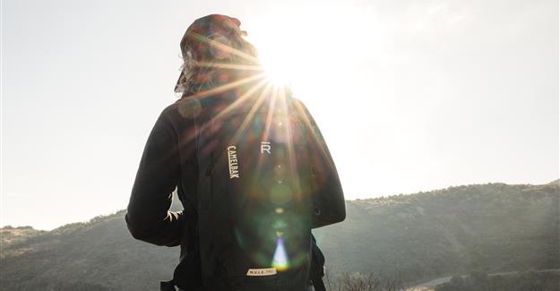 Hiker with a sunburst near head