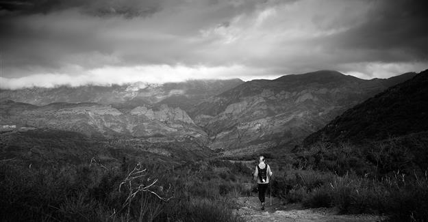 Hiker walking down path