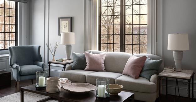 Lounge area with a plush couch and natural light