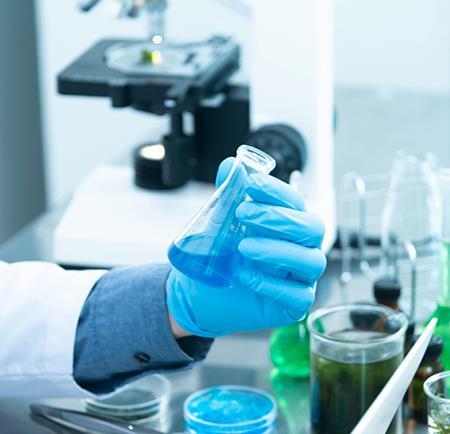 A hand holding a flask in a lab