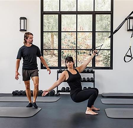 Woman stretching with a gym machine