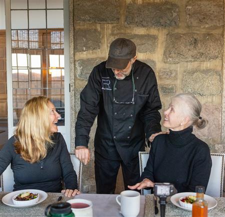 two women talking with chef