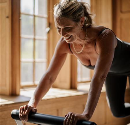 Woman stretching with a gym machine