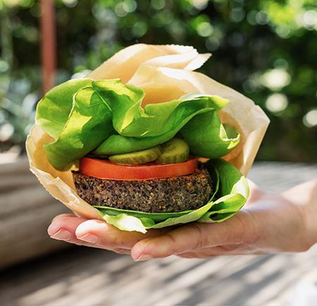 Chef adding sesame seed garnish to a veggie wrap