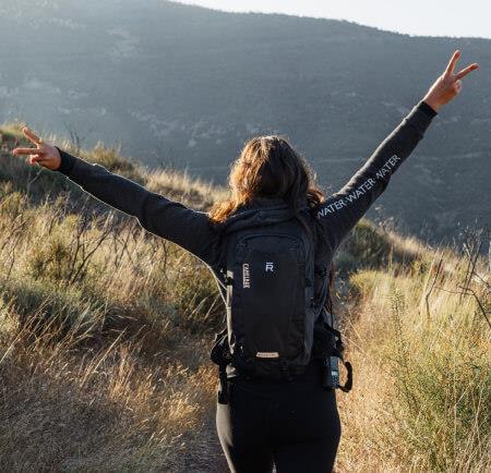 A woman hiker with arms outstretched