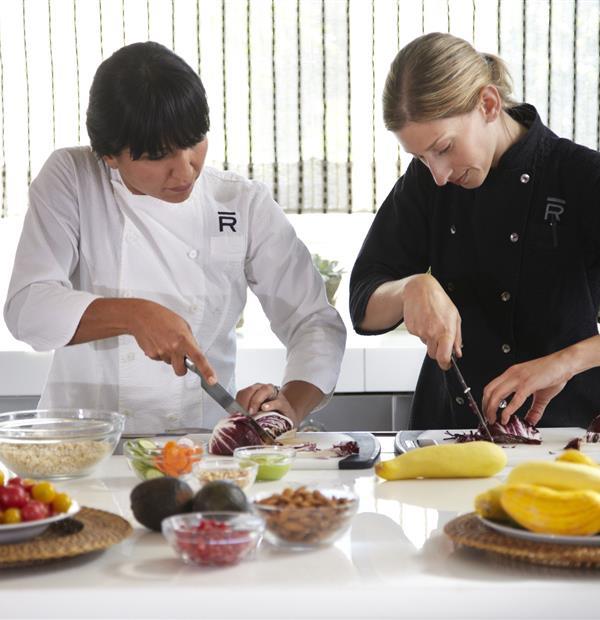 Two chefs cutting food