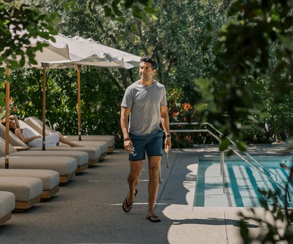A man walking by the pool