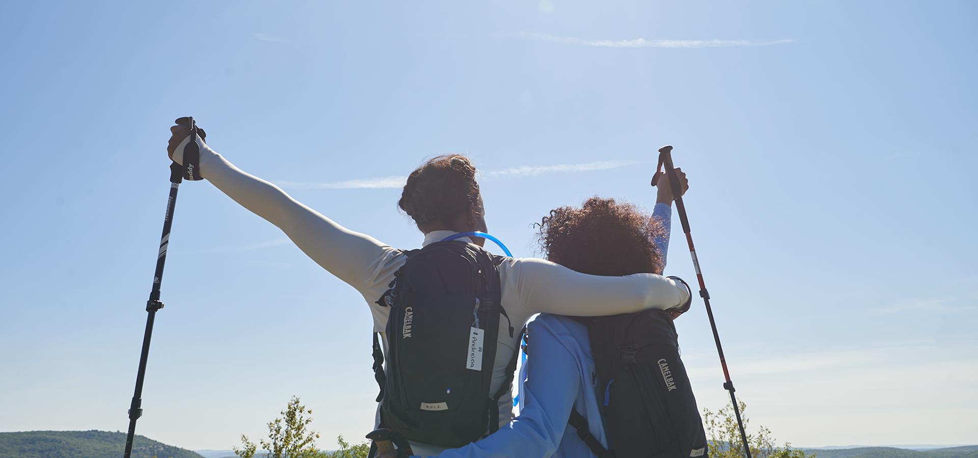 a couple hiking, enjoying the view