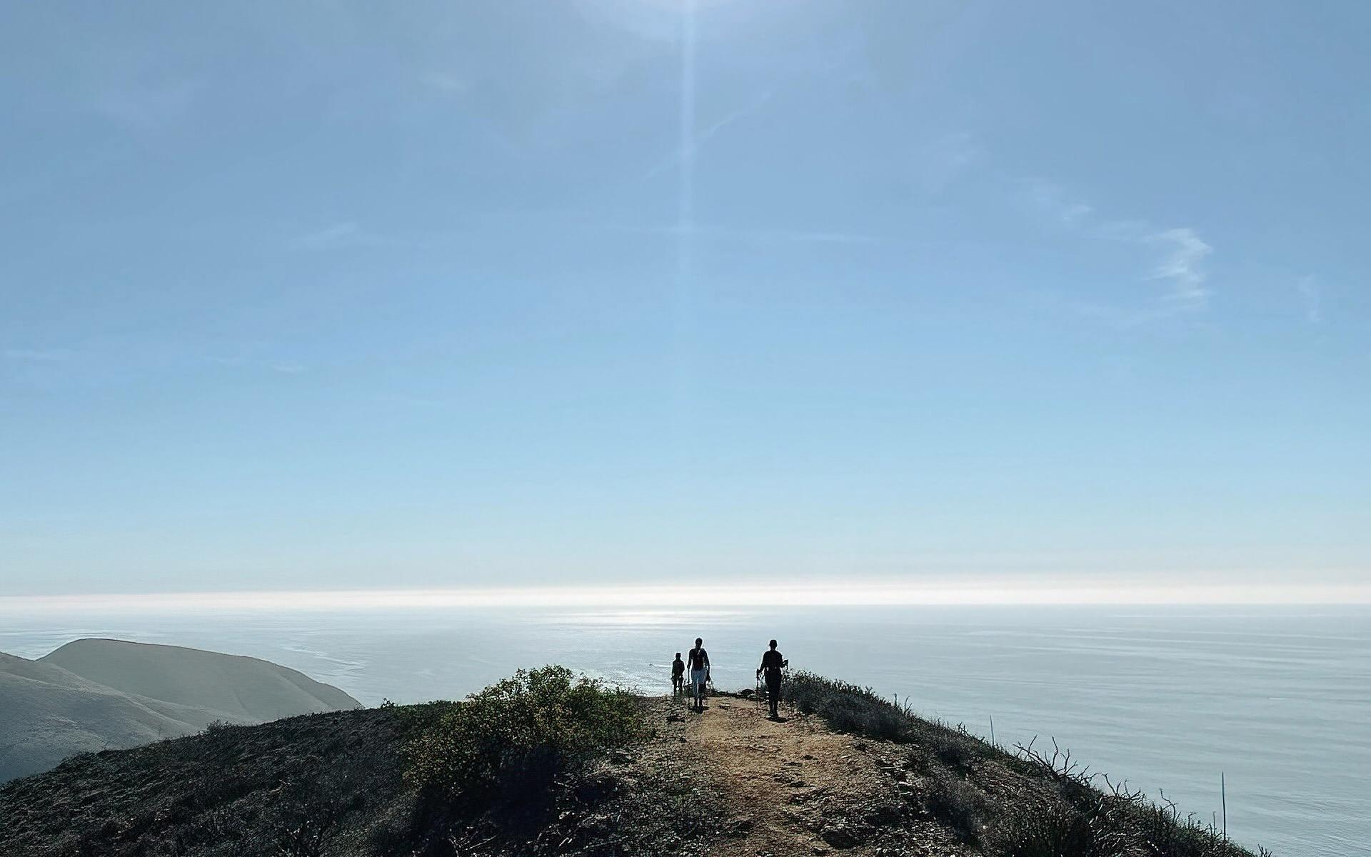 A group of hikers overlooking the ocean