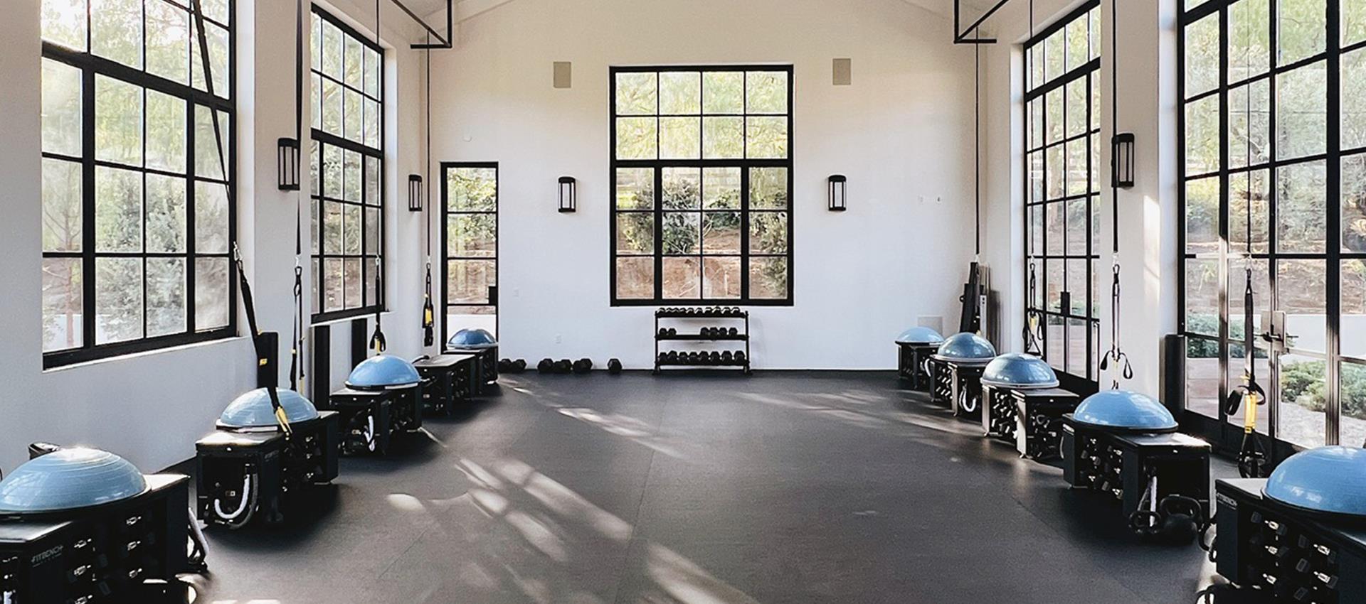 Fitness room equipped with TRX suspension trainers and gym equipment