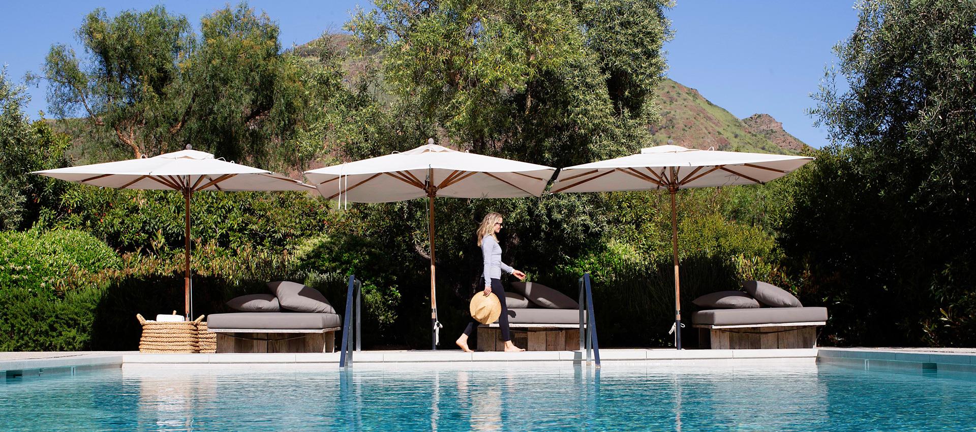 A woman walking along the pool